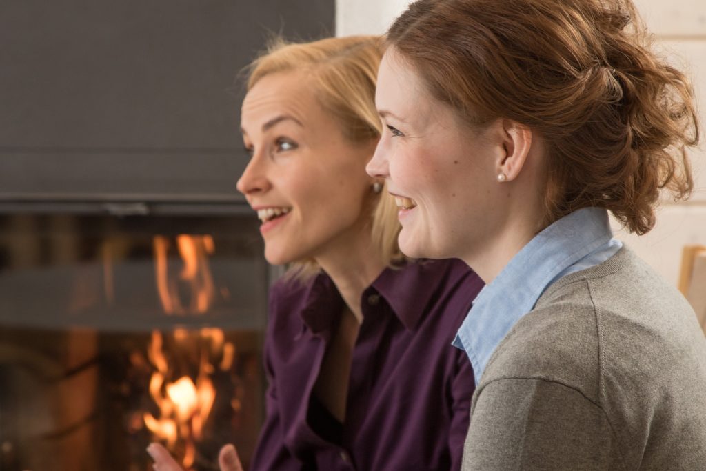 Women Fireplace Conversation Stock Photo